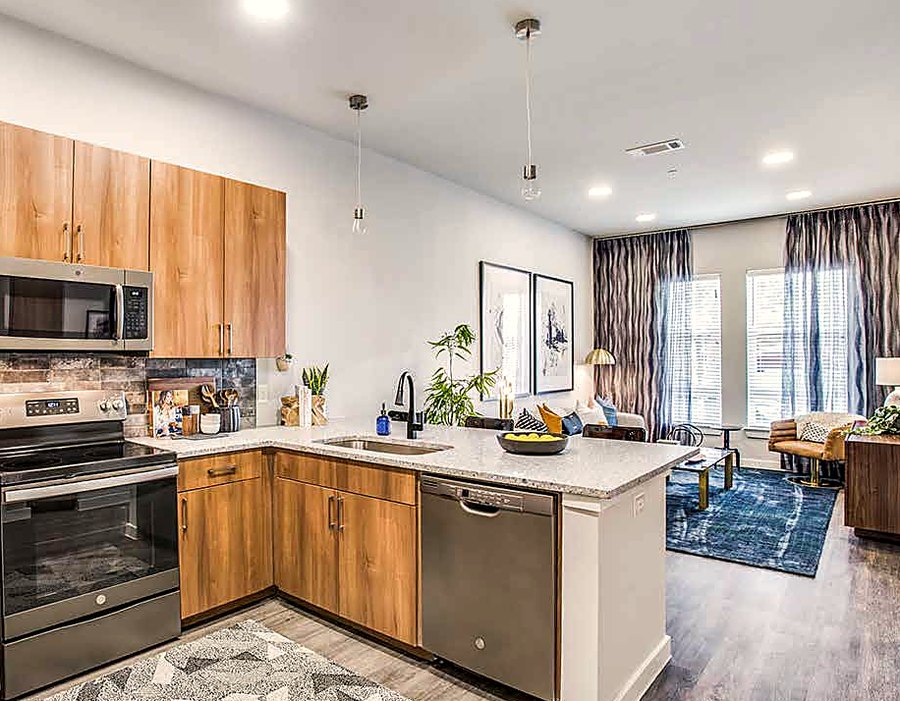 Modern kitchen with quartz counters in a Cooper apartment home
