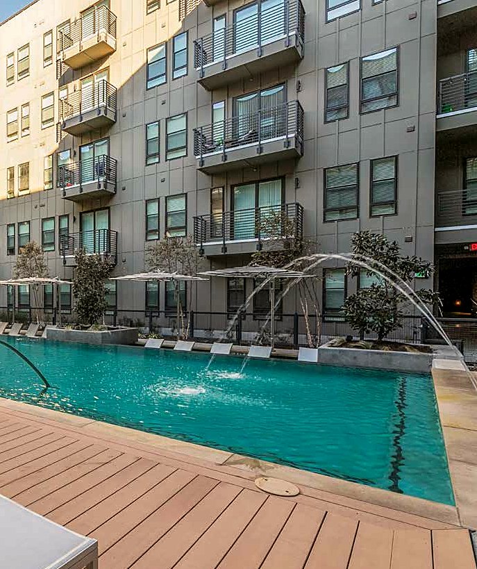 Daytime pool with fountain jets at The Cooper apartments