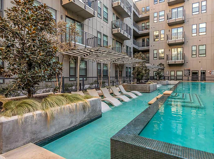 Resort-style pool area at The Cooper apartments, daytime