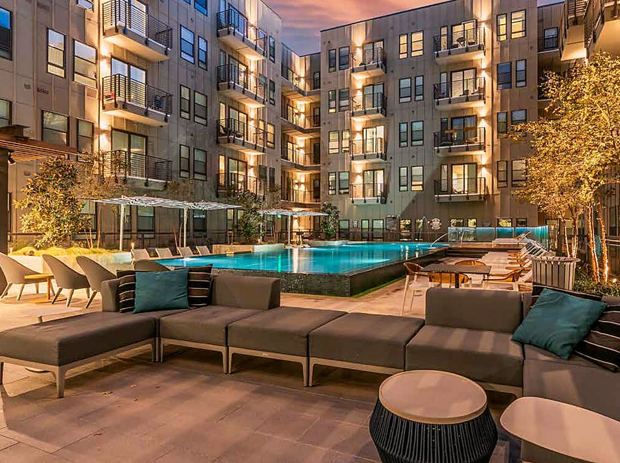 Poolside sofas at sunset at The Cooper apartments